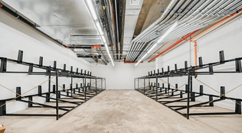 Bicycle storage room with ceiling mounted racks